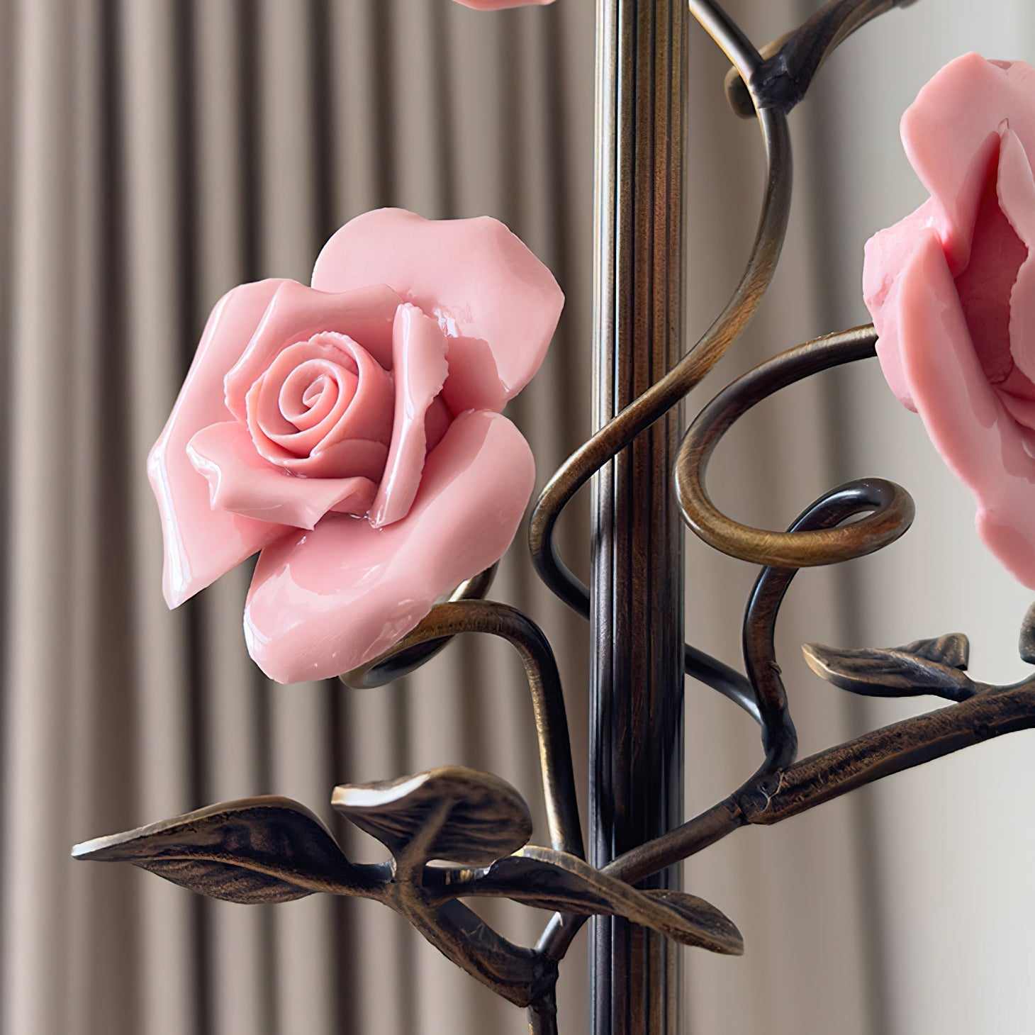 The blue glass rose sconce, lit, creating a cool ambiance.
