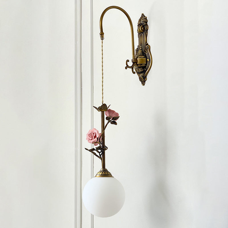 The clear glass rose sconce shown from a low angle.