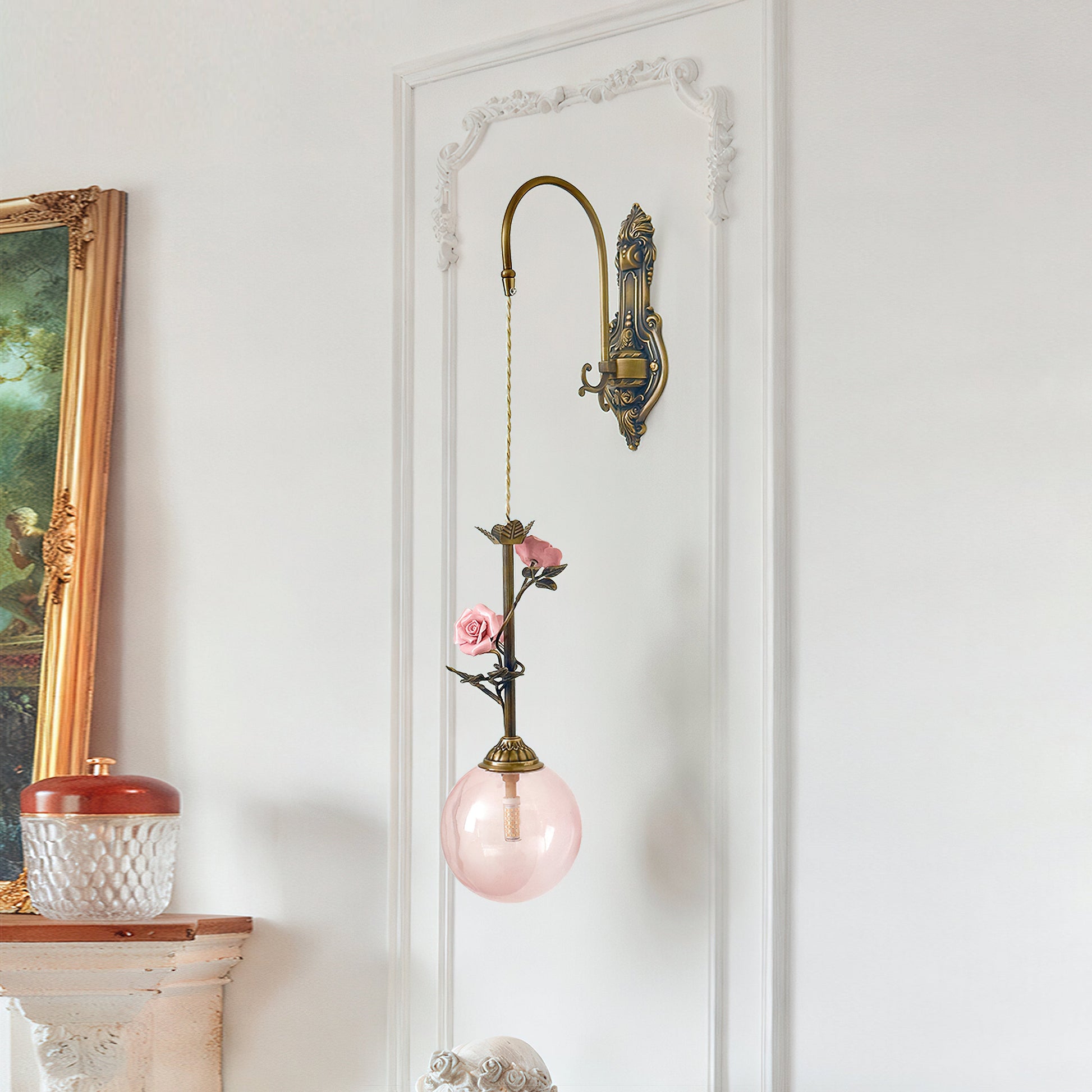 Close-up view of the pink glass rose shade of the Evelyn sconce.