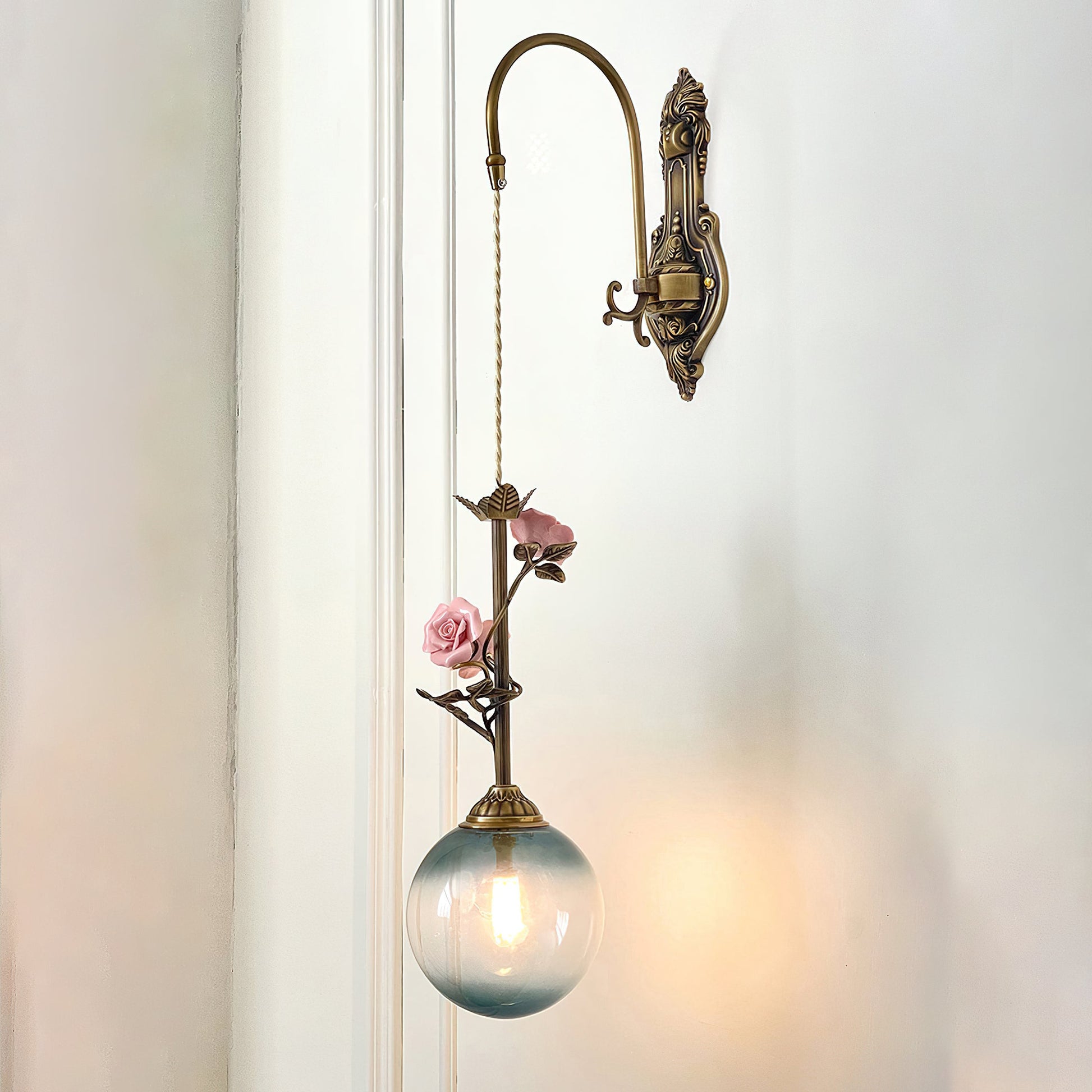 A pair of Evelyn wall sconces installed on either side of a bed.