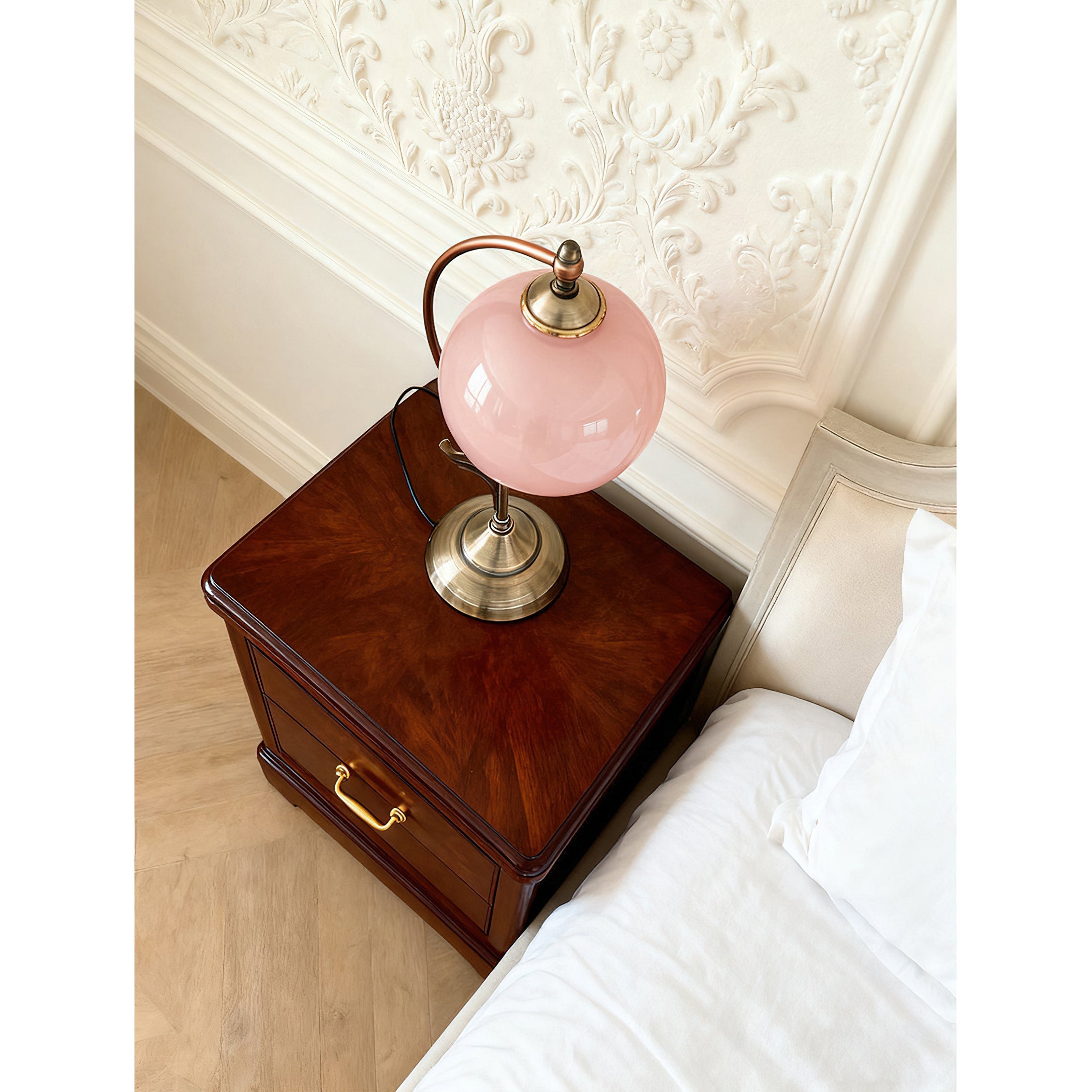 Side profile of the Evelyn Glass Table Lamp showcasing its graceful metal arch.