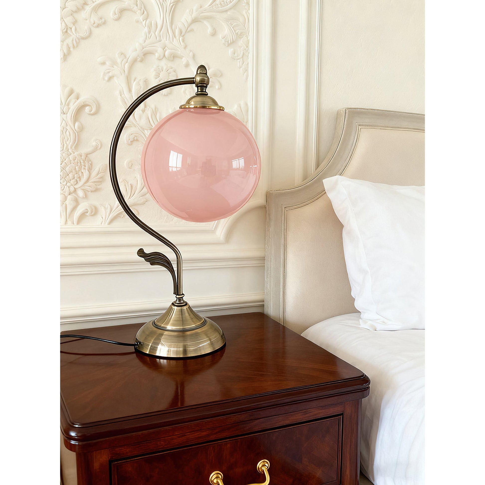 The Evelyn Glass Table Lamp shown in a bedroom setting on a nightstand.