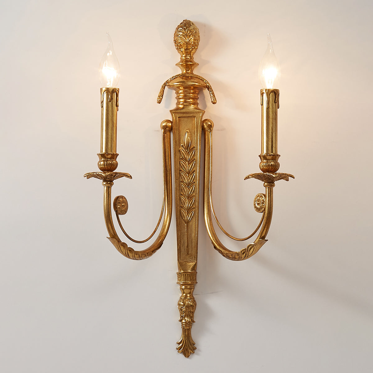 The Fabienne Wall Lamp casting a cozy, inviting light in a bedroom setting.