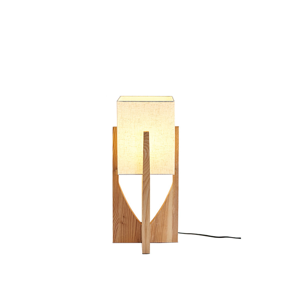 Fairbanks Table Lamp with a white fabric shade and wooden tripod base, shown on a side table.