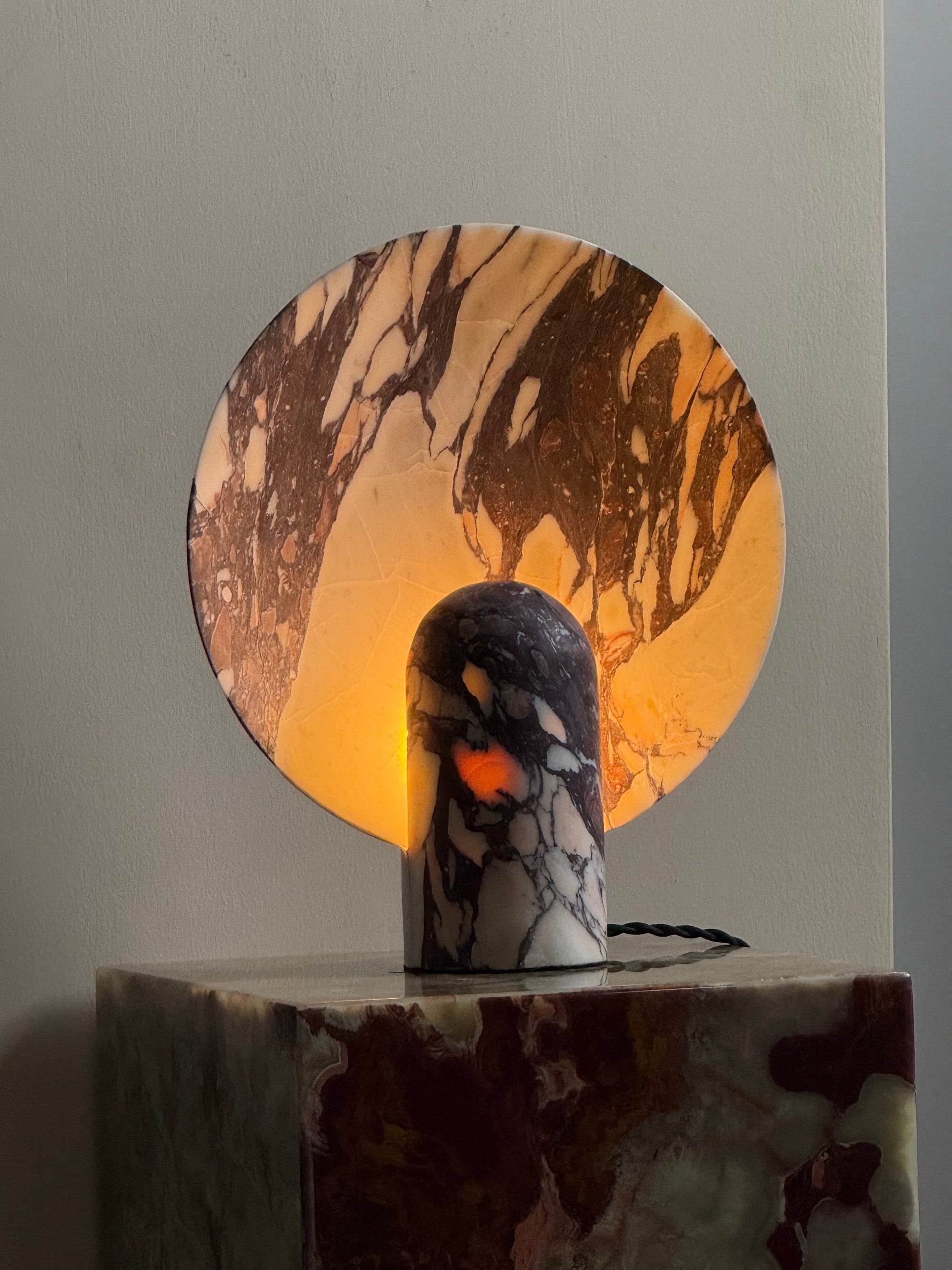 Detail shot of the natural veining on the cyan onyx Fan Table Lamp.