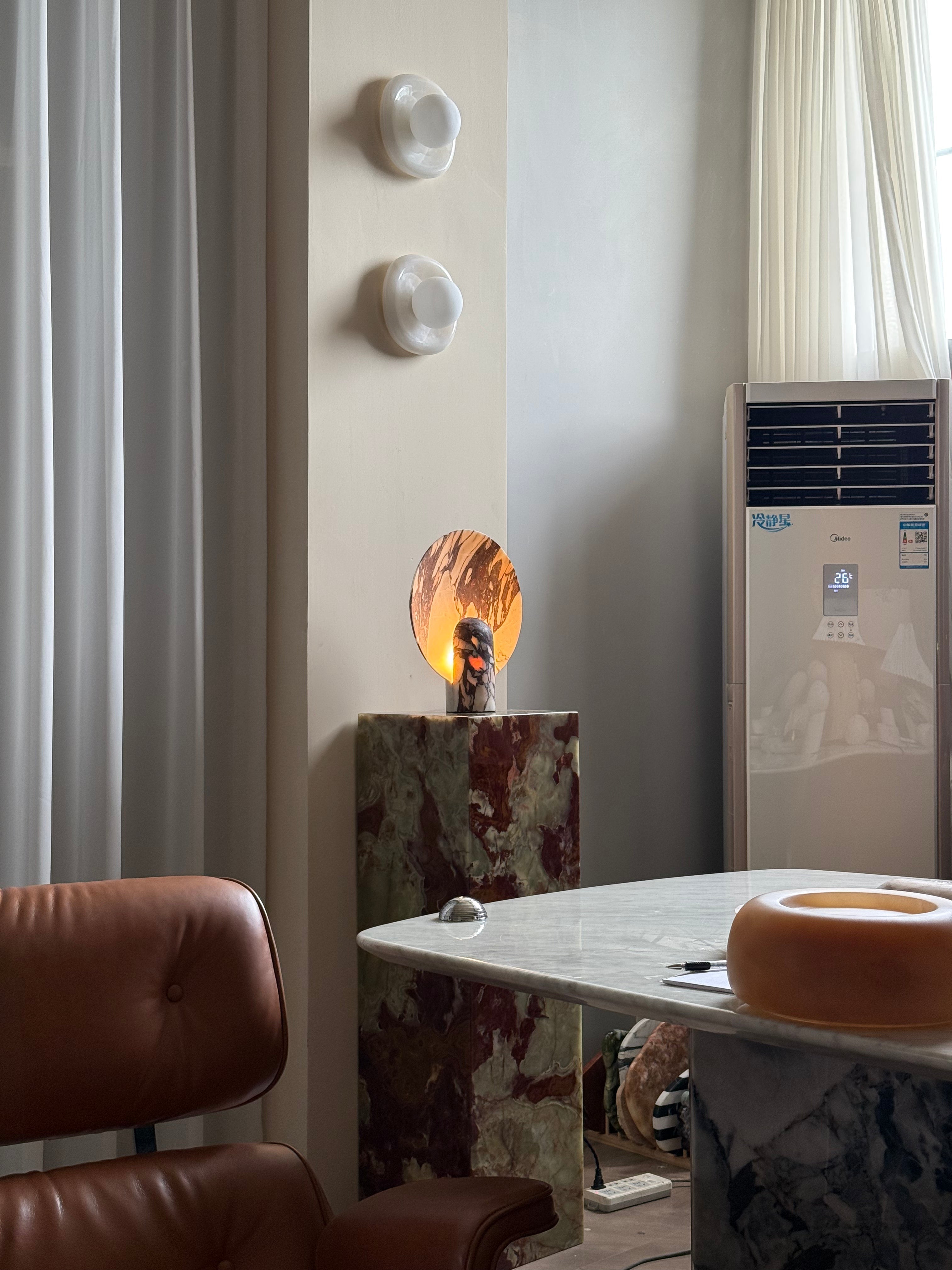 Grey marble Fan Table Lamp on a minimalist desk.