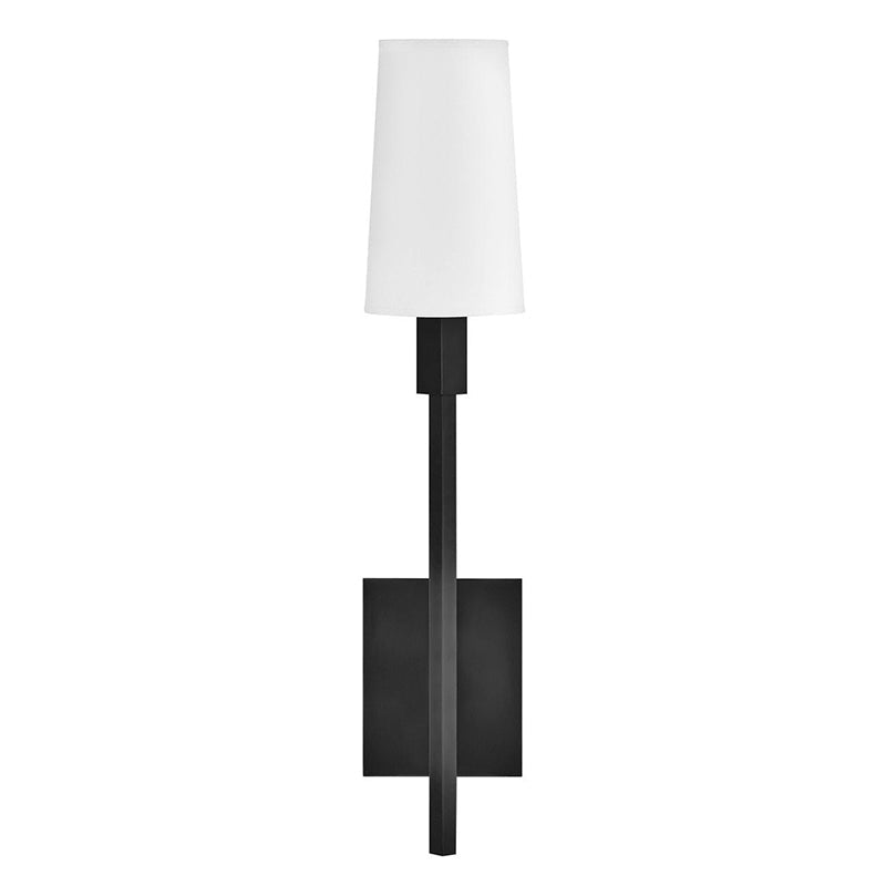 Fenwick Wall Lamp casting a warm ambient light in a bedroom.