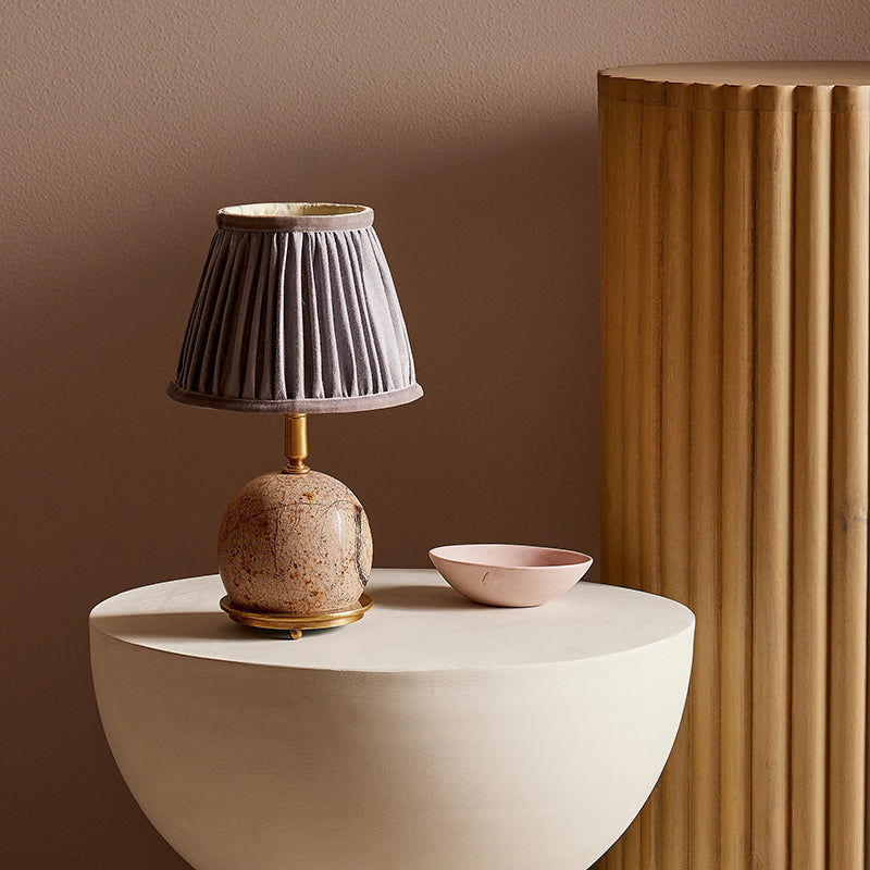 The Ferdy Table Lamp shown in the Pink marble finish.