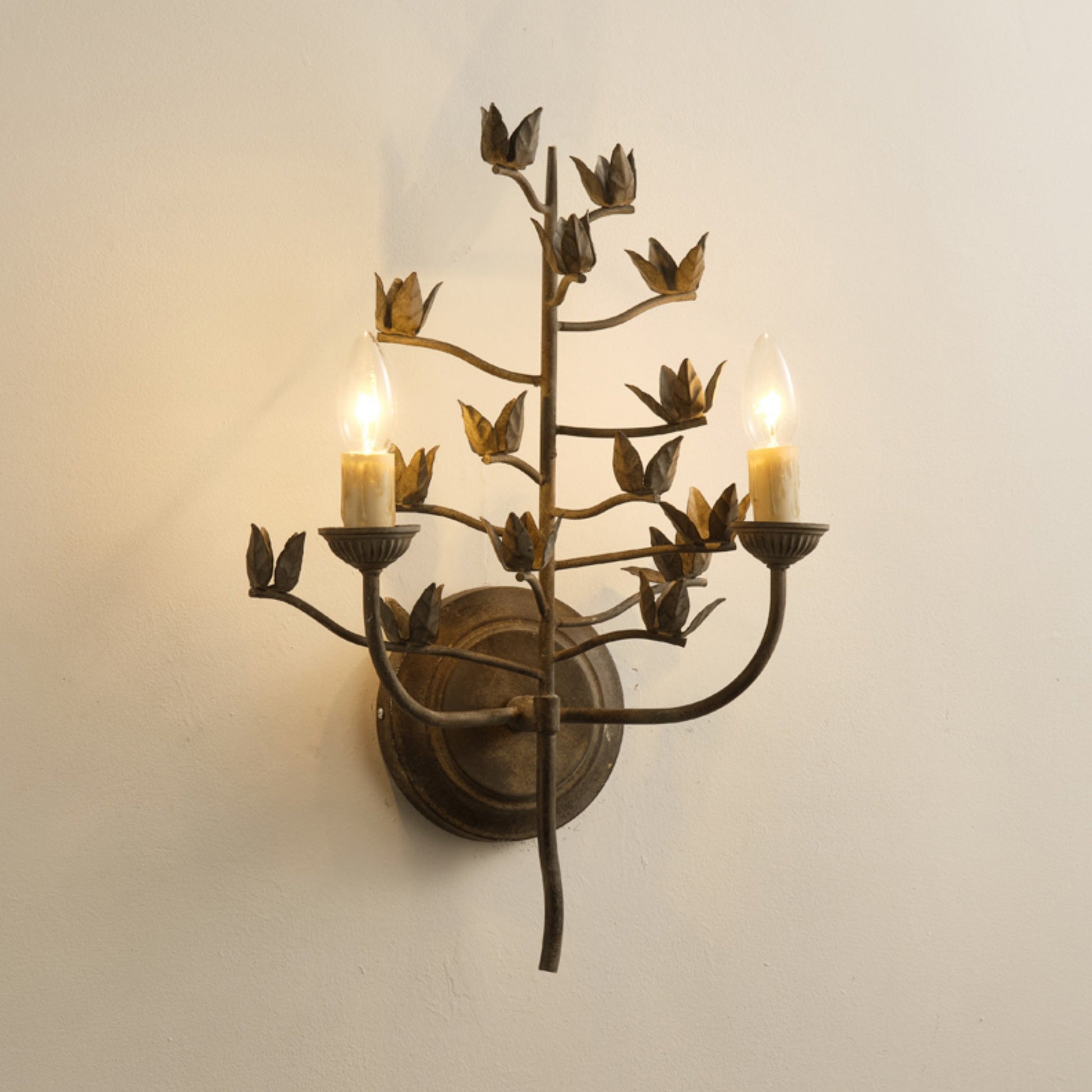 Ferroarte Branch Wall Lamp in a minimalist bedroom setting.