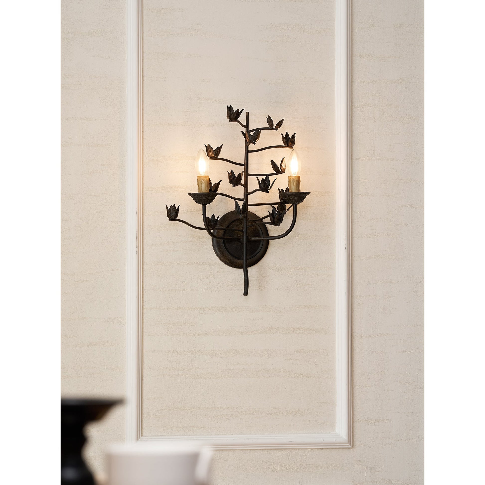 Ferroarte Branch Wall Lamp against a dark-colored wall for contrast.