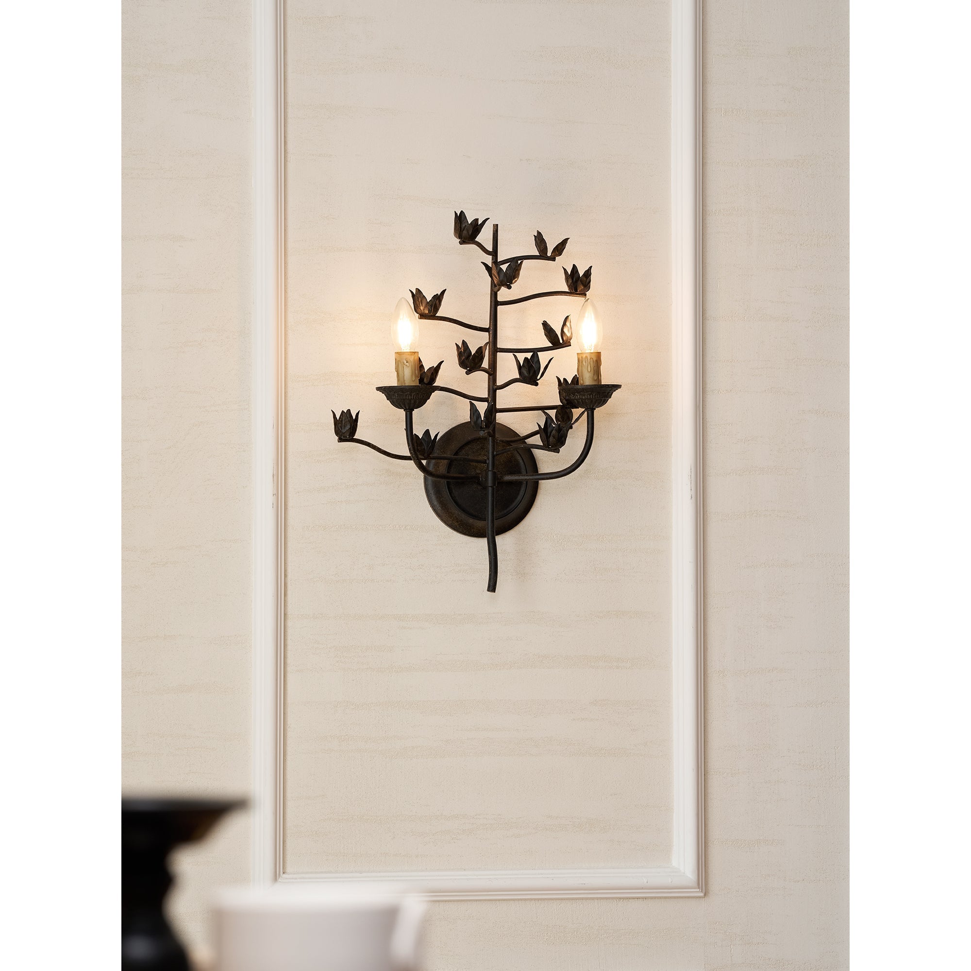 Ferroarte Branch Wall Lamp against a dark-colored wall for contrast.