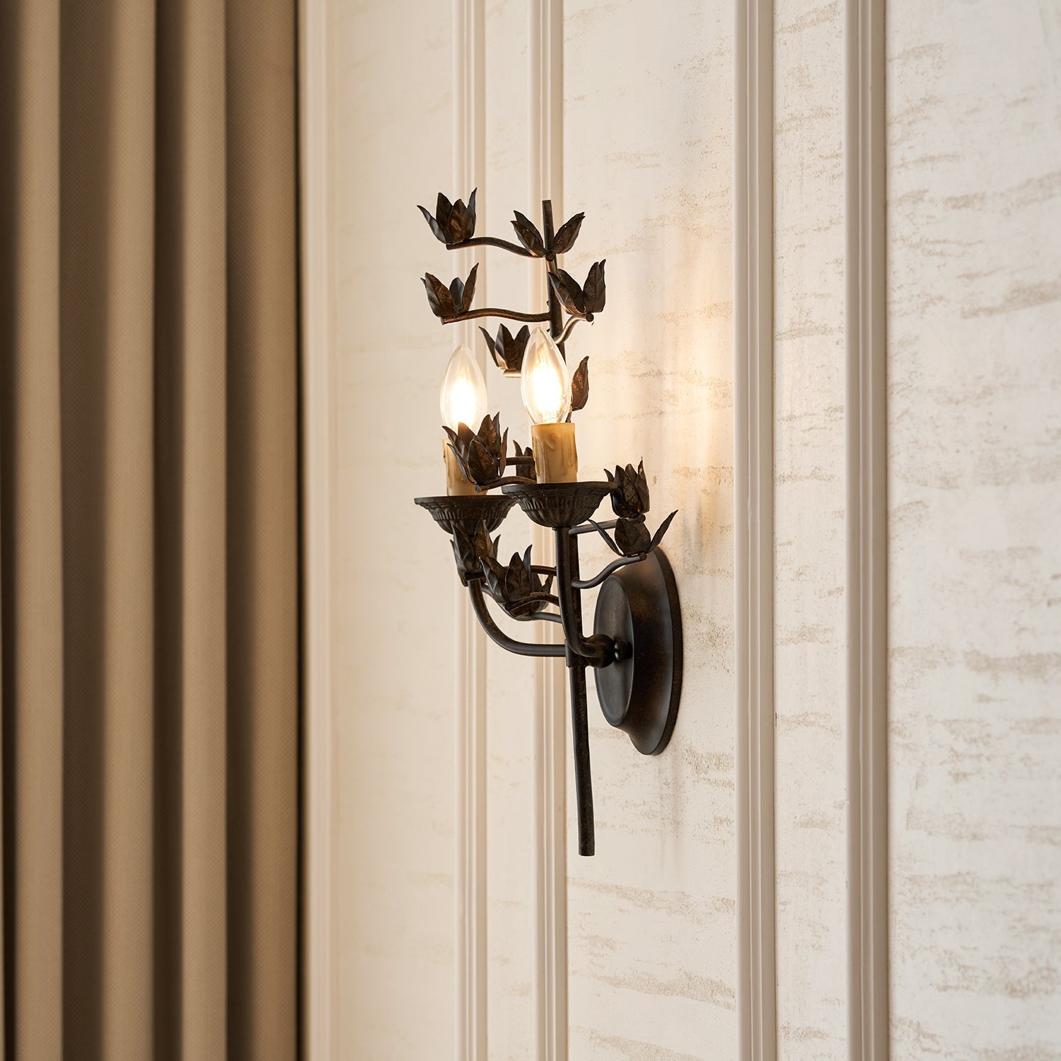The wall lamp from a low angle, highlighting its sculptural design.