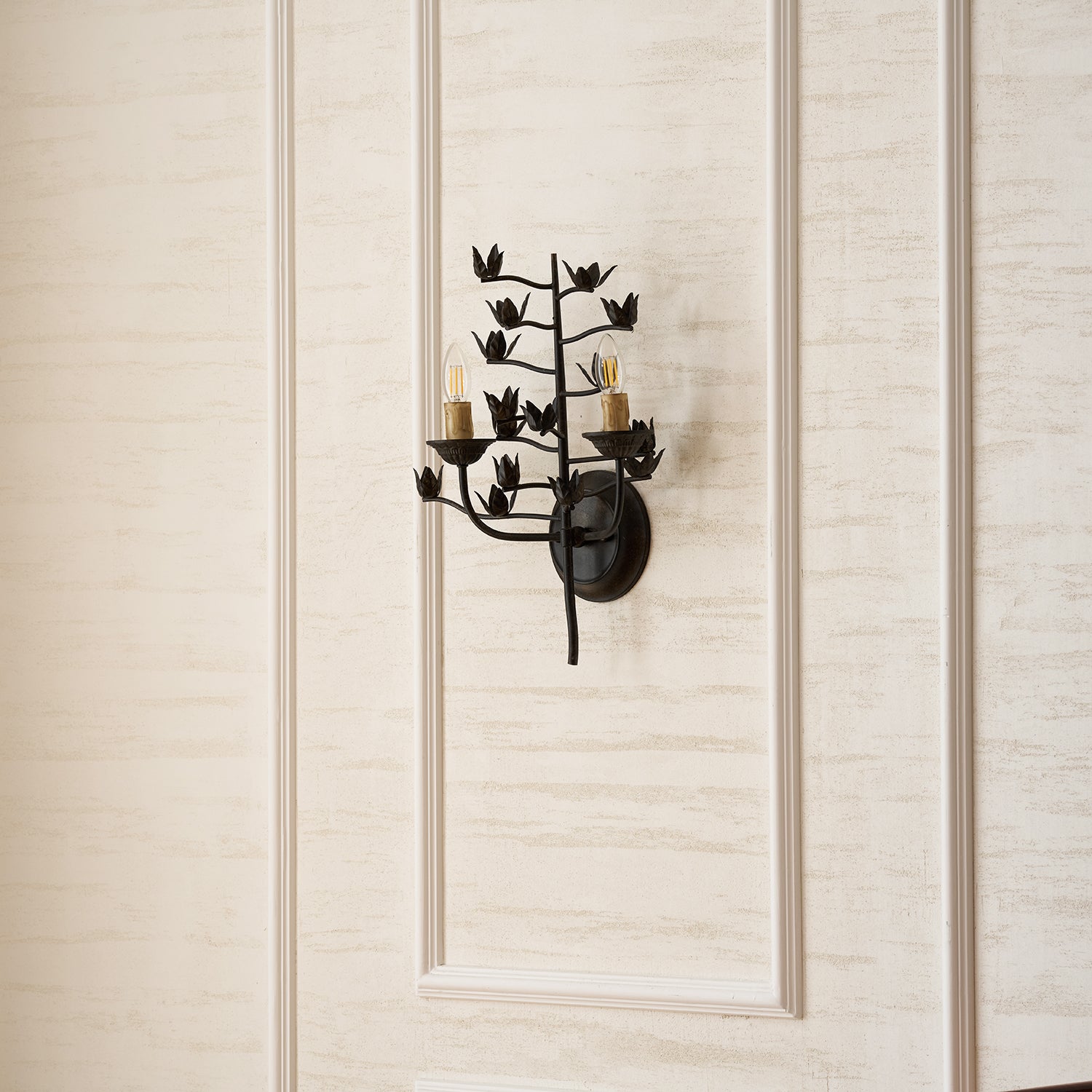 Lifestyle image of the branch wall lamp in a rustic-themed interior.
