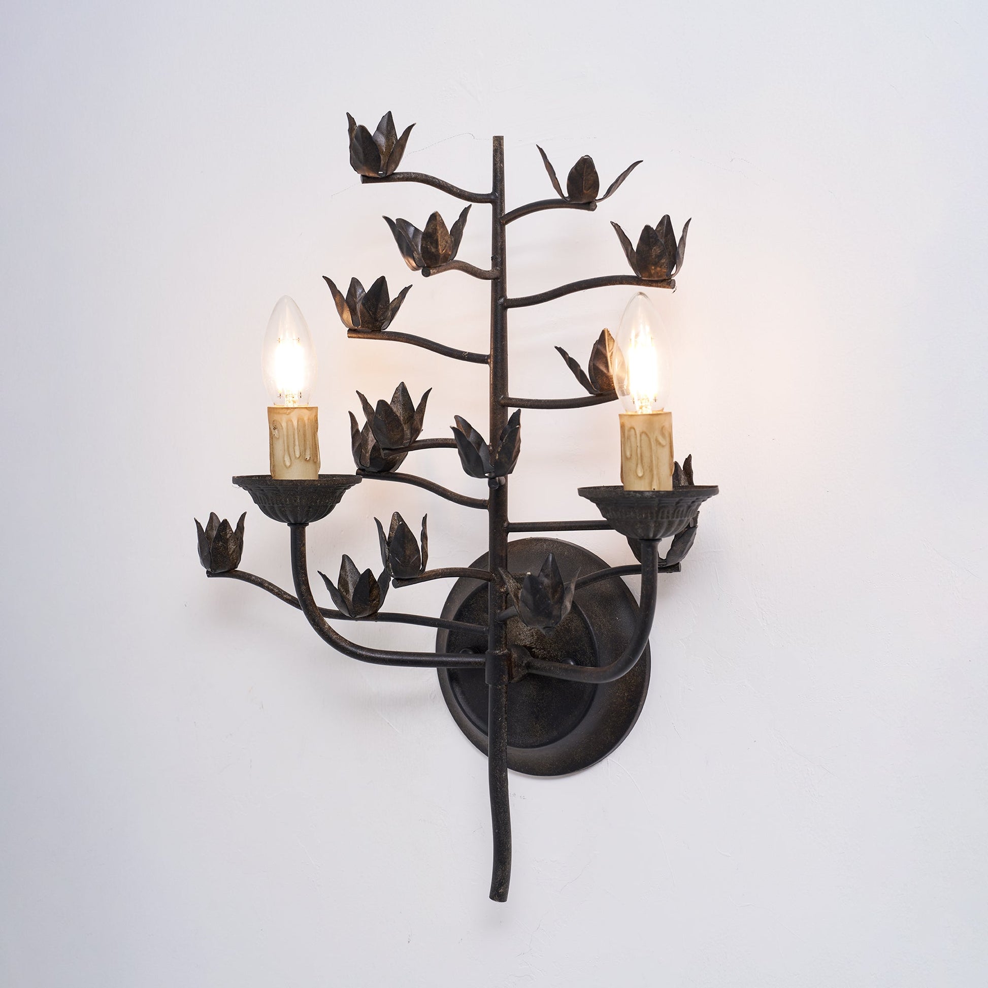The lamp's sculptural form against a textured wall.