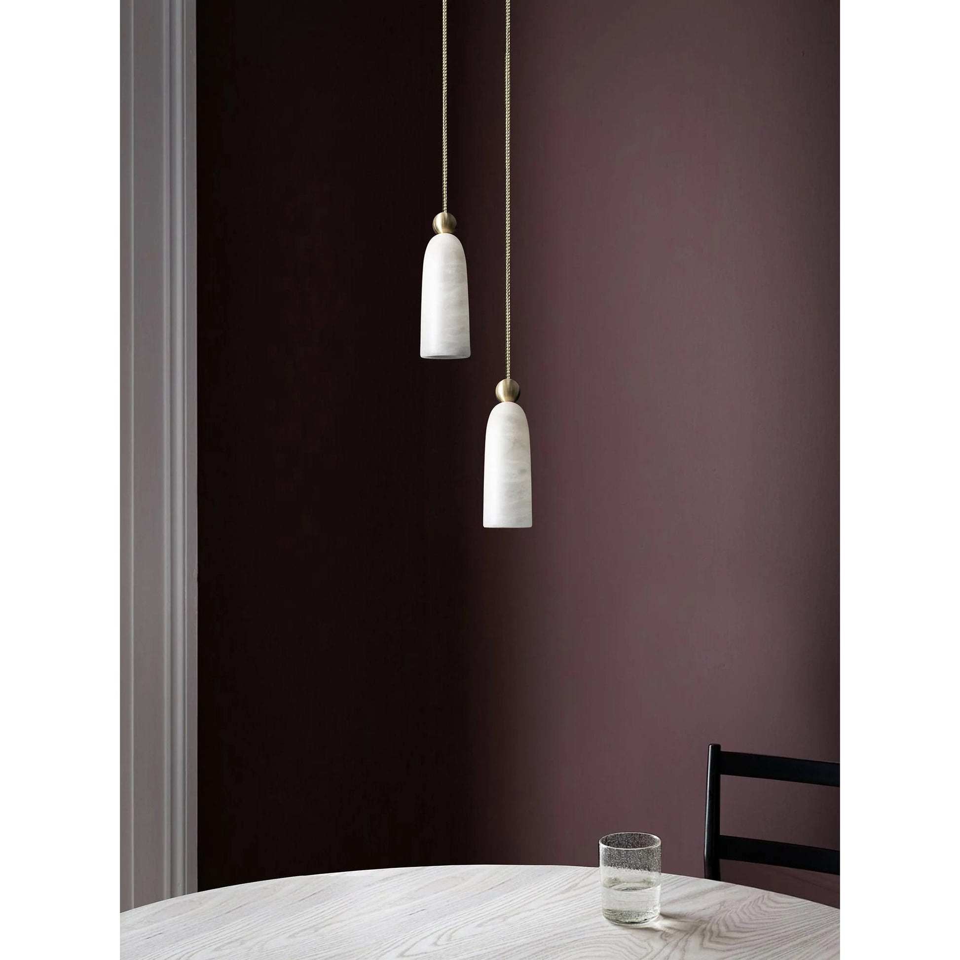 The Figure pendant light shown unlit to display the natural white alabaster stone.