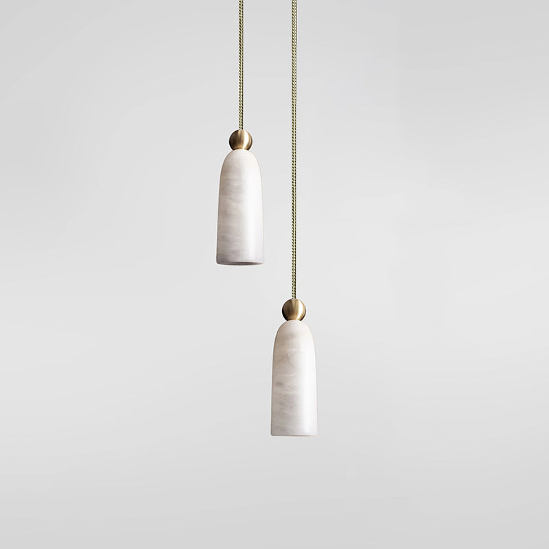 Two Figure pendants flanking a bathroom vanity mirror.