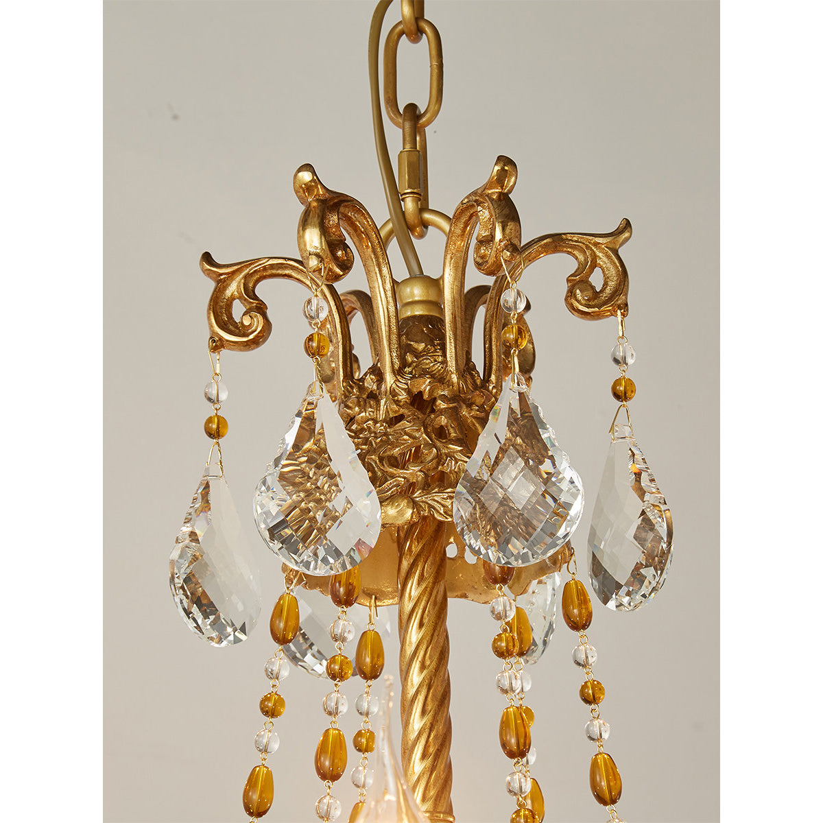 The intricate craftsmanship of the Filmore Chandelier's brass body.