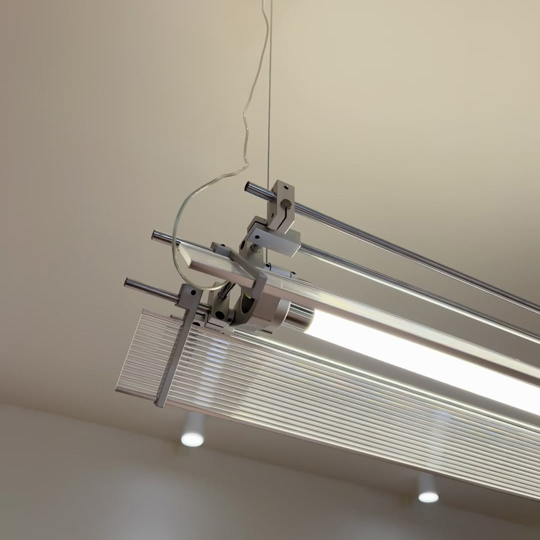 The Filtro lamp's clear glass shade and silver aluminum details.