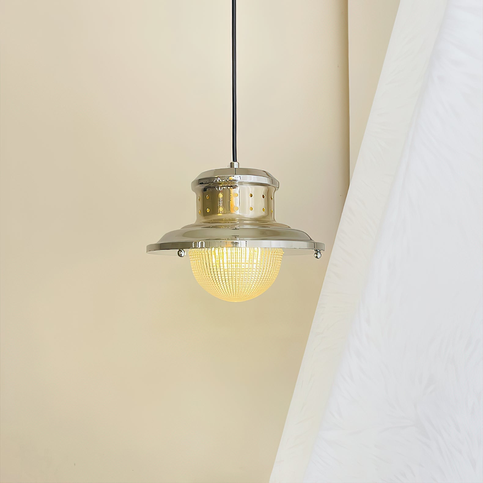 Close-up view of the chrome metal body of the Fisherman's Pole Pendant Lamp.