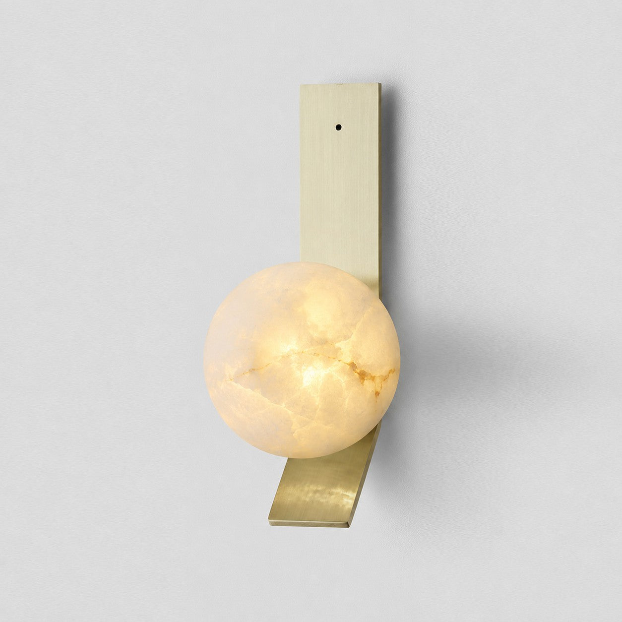 The Fizi sconce mounted on a dark wall for a high-contrast look.