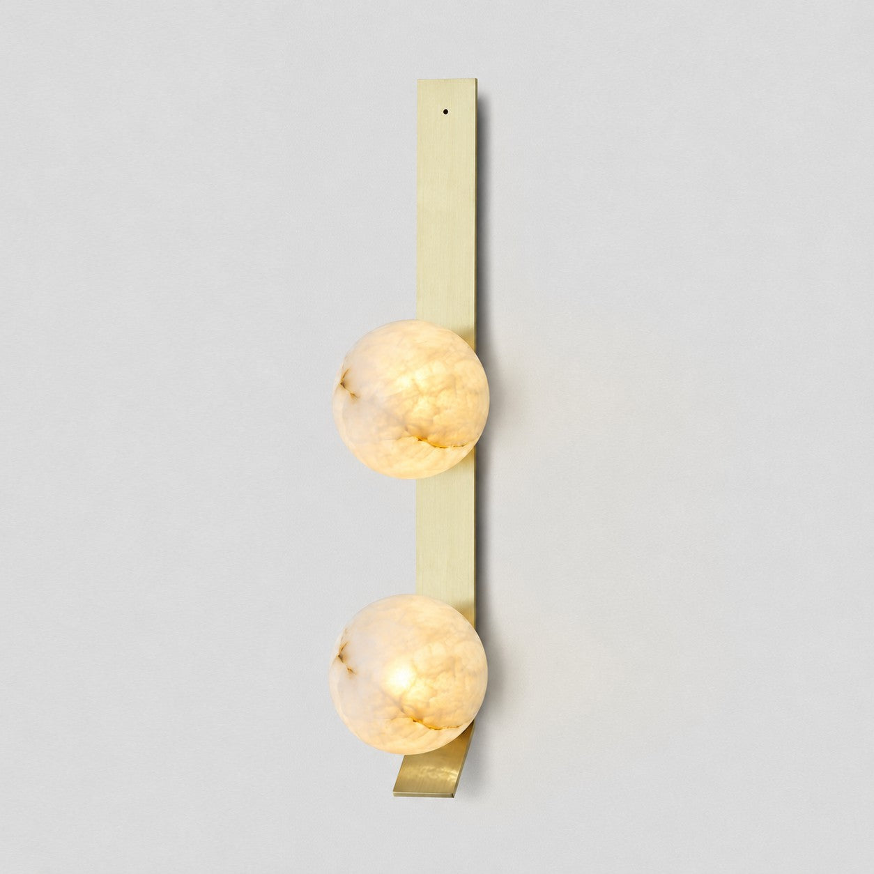 Texture detail of the brushed brass body of the Fizi wall sconce.