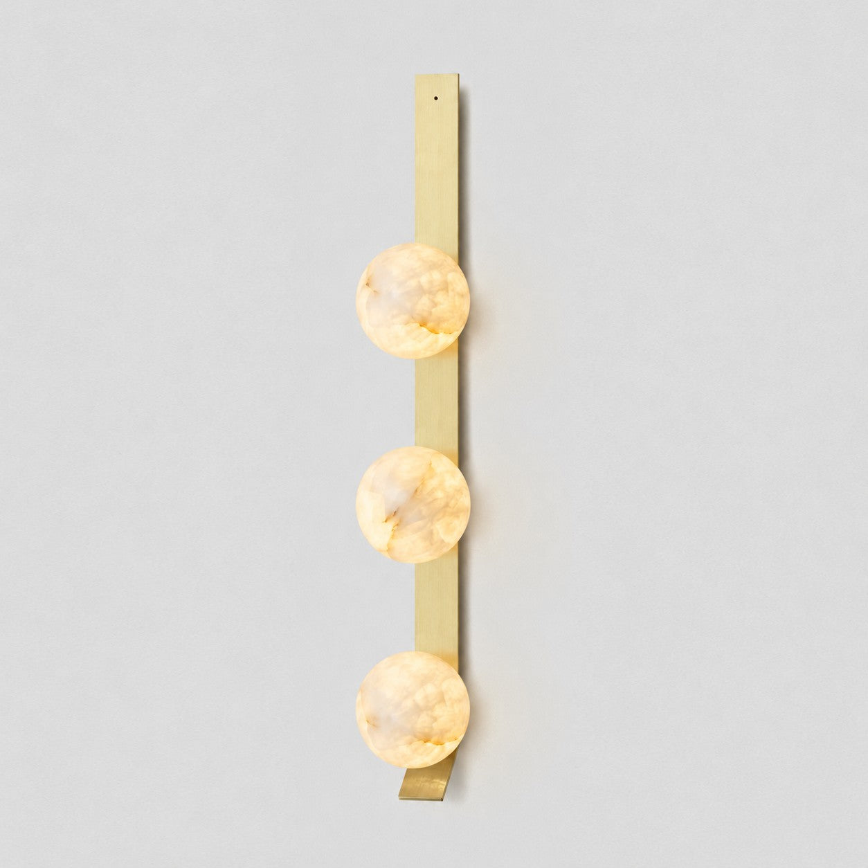 Full frontal view of the Fizi Alabaster Wall Sconce on a plain white background.