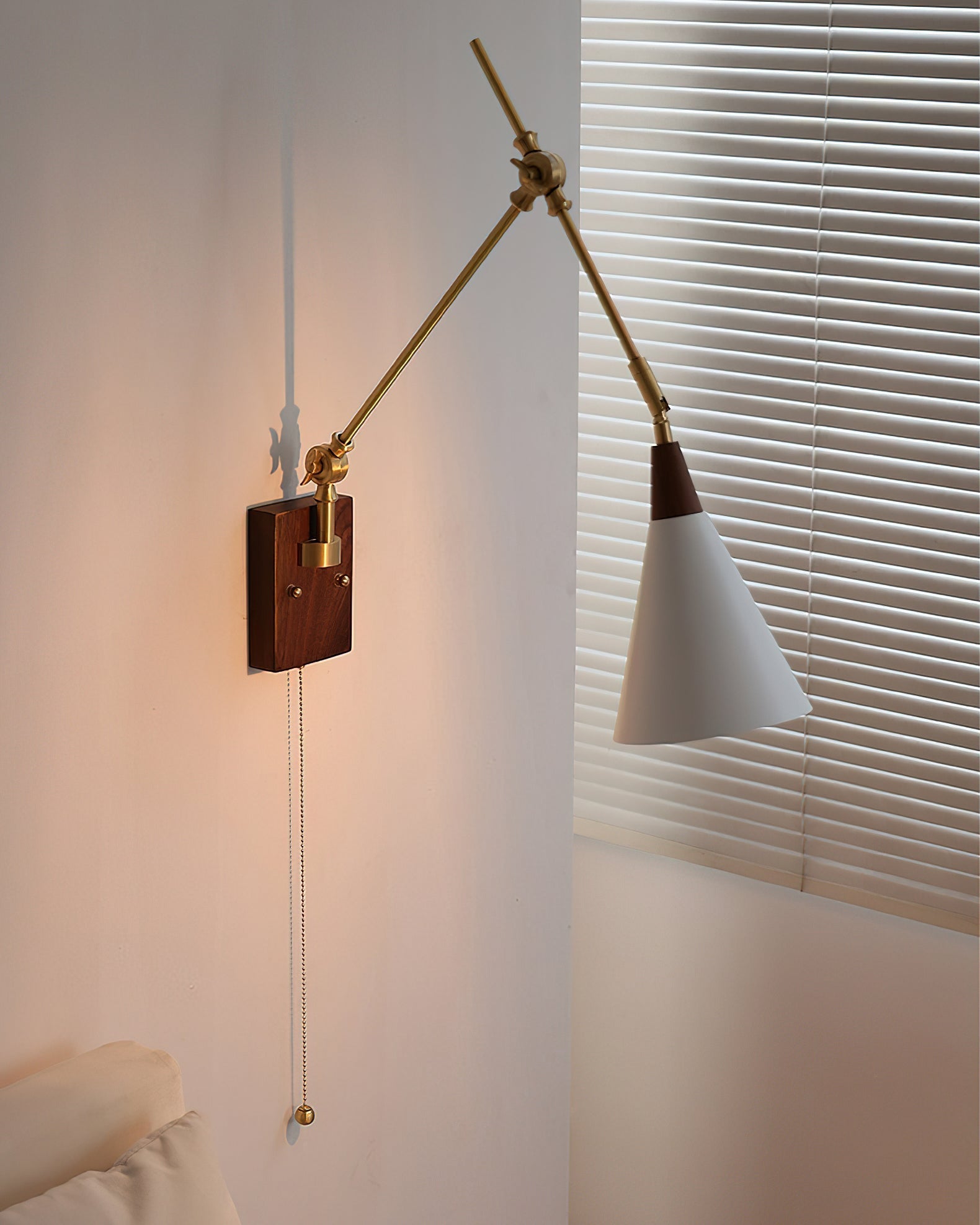 The Fleka Swing Arm Wall Lamp extended over a reading nook.