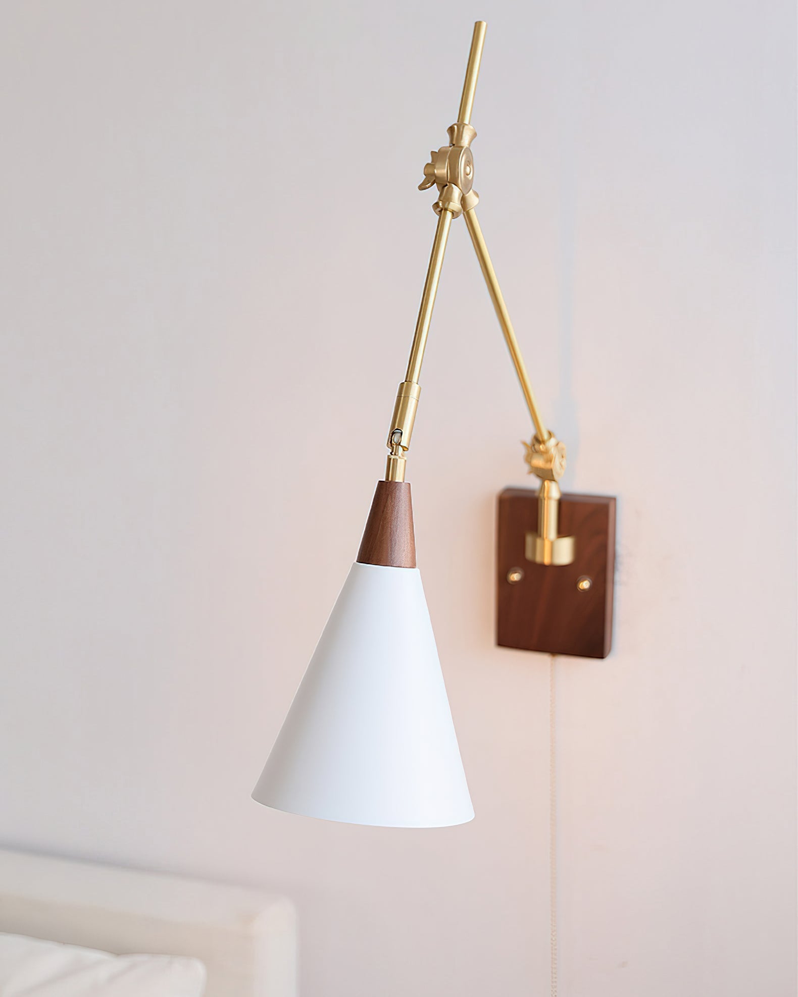 The Fleka Wall Lamp installed in a contemporary bedroom setting.