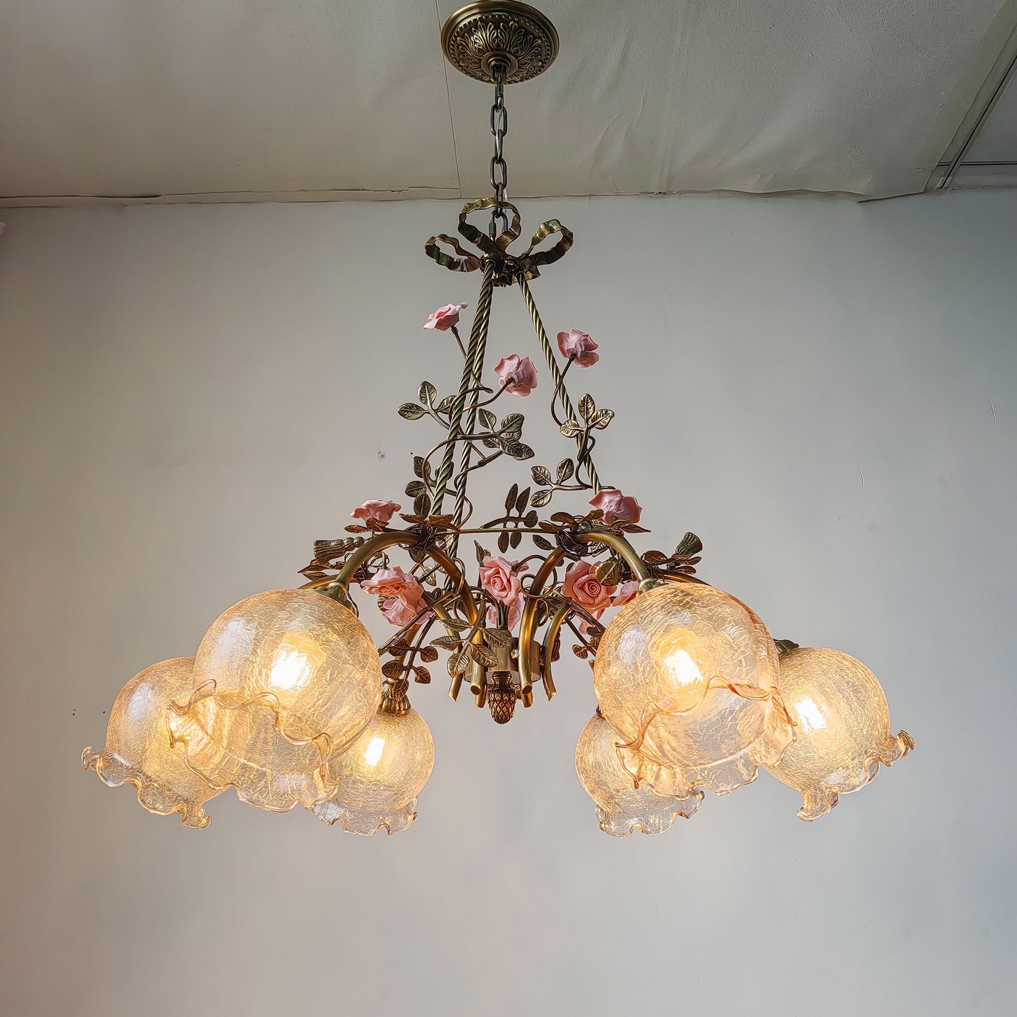 The Flora Blossom Chandelier hanging in a dining room setting.