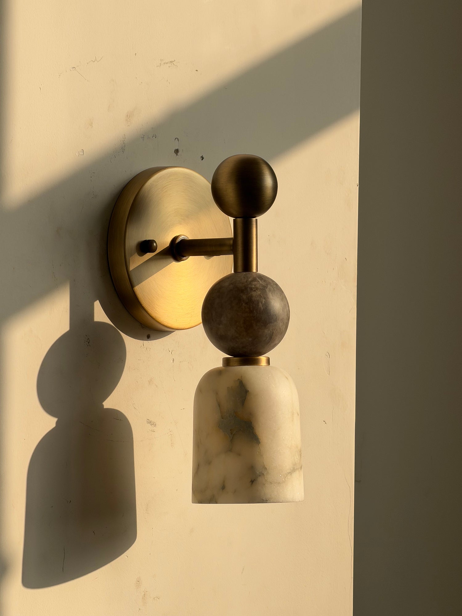 The lamp turned off, displaying the textures of the stone and metal.