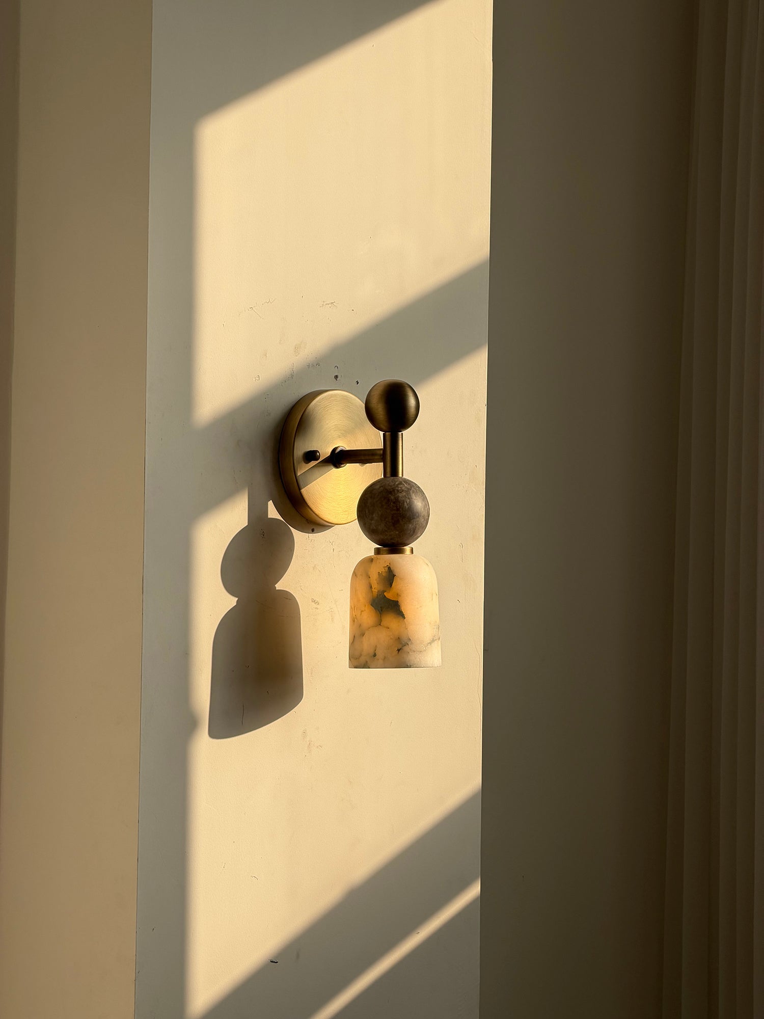 The Flume Wall Lamp shown against a light, minimalist wall.