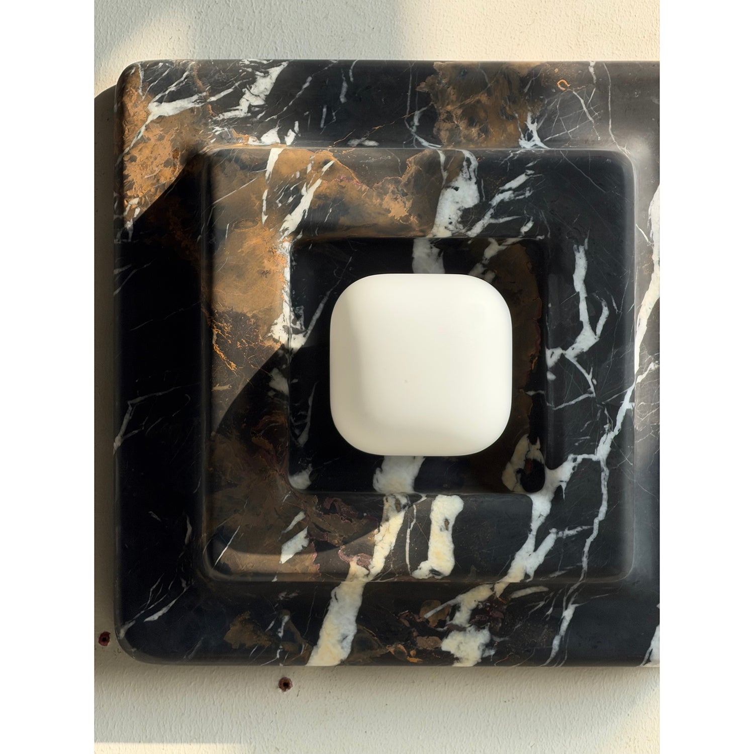 White and black marble wall lamps shown side-by-side for comparison.