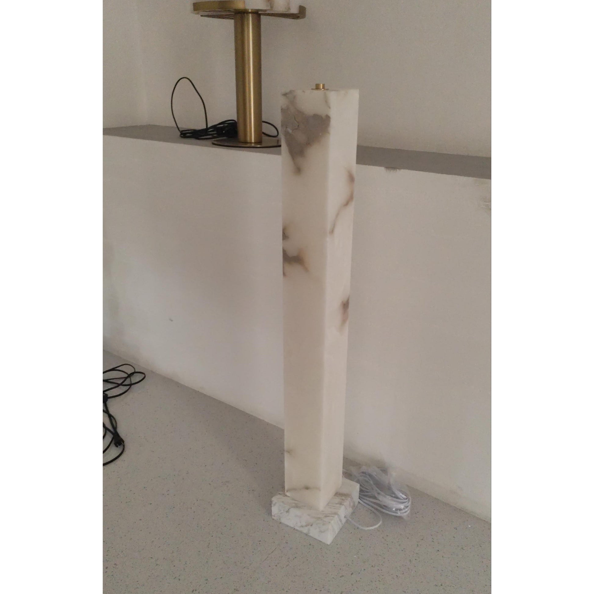 The floor lamp in an office or study environment.