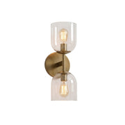 Garrison Glass Wall Sconce with antique brass finish and clear shade.