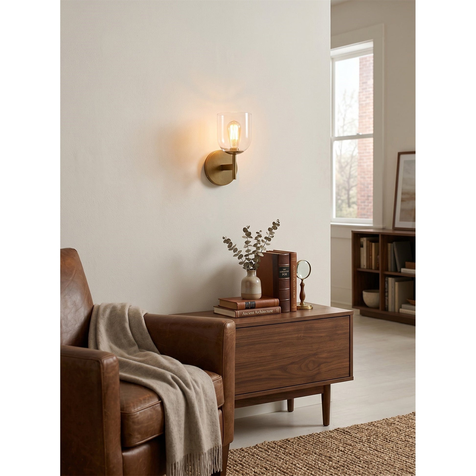 The Garrison sconce installed in a modern bathroom next to a mirror.
