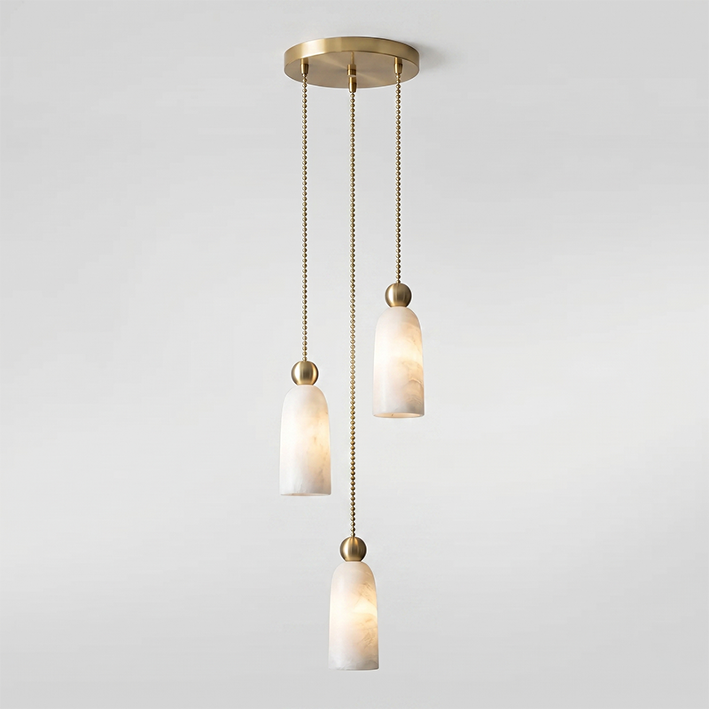 The seamless connection between the alabaster shade and the brass cap.