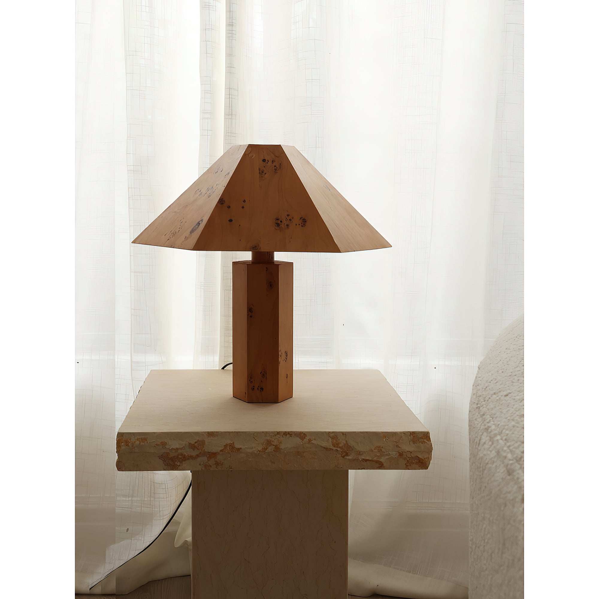 The lamp's silhouette against a wall.