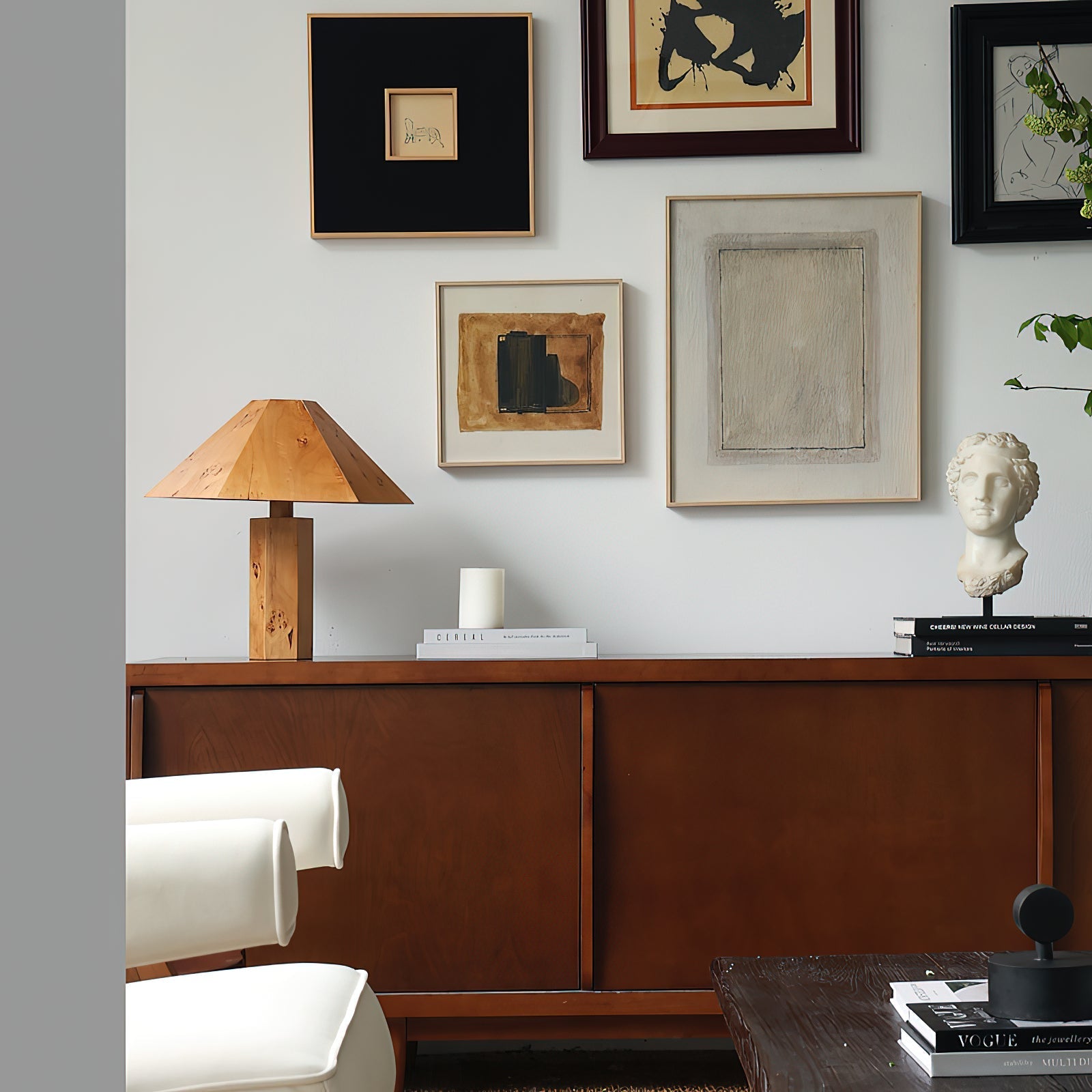 The Gena Table Lamp shown in a living room setting, providing warm light.