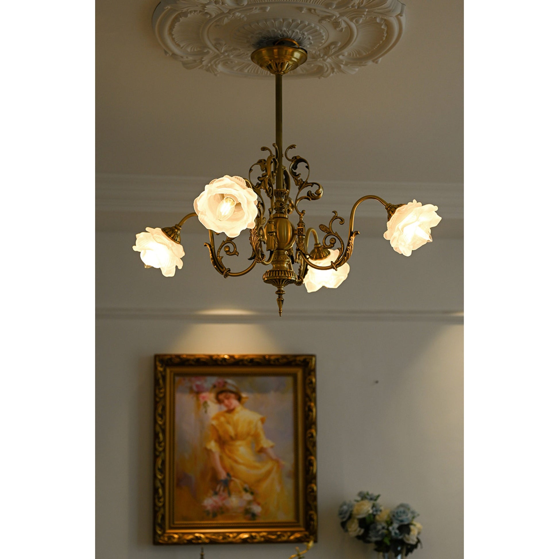 Chandelier illuminating a dining room table.