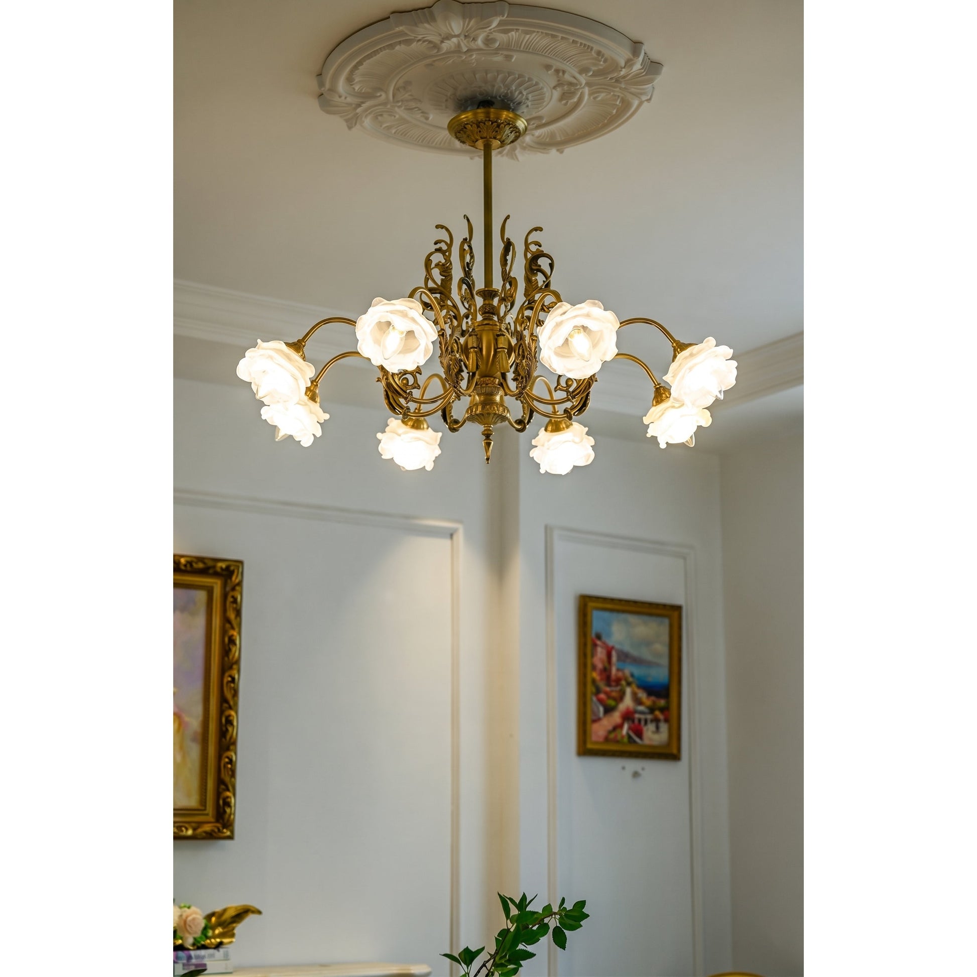 The chandelier's central column with decorative elements.