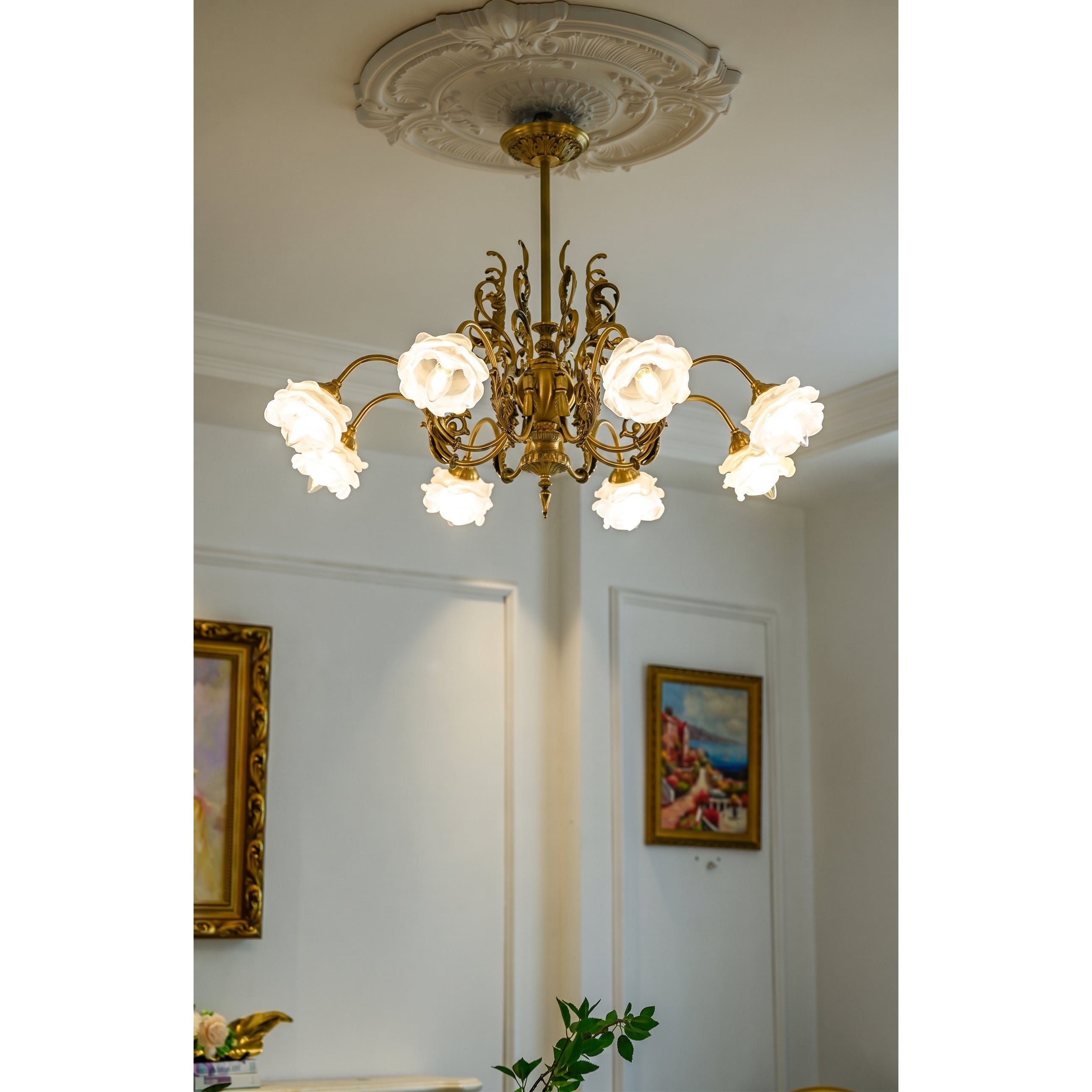 The chandelier's central column with decorative elements.