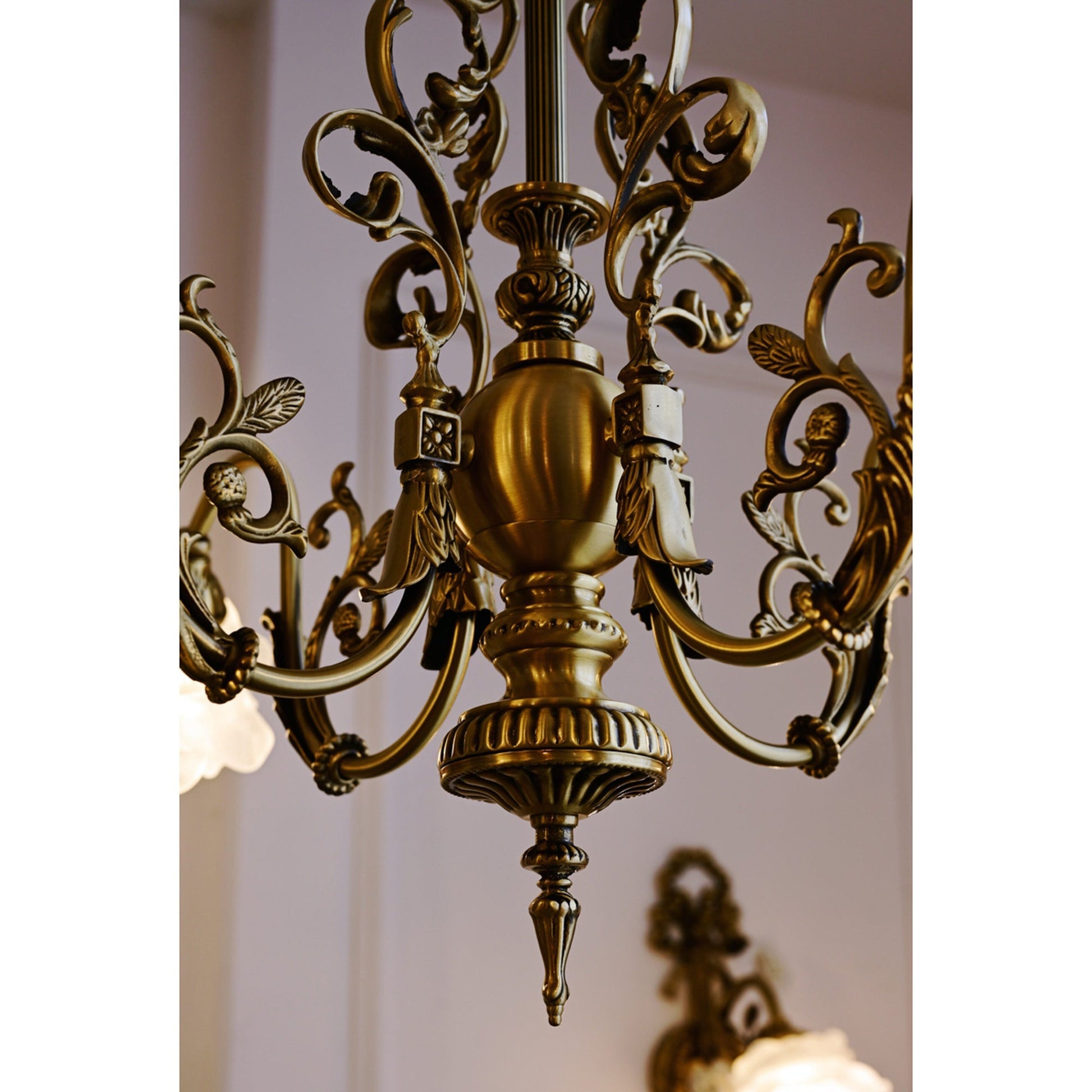Detail of the winding vine-like arms of the chandelier.