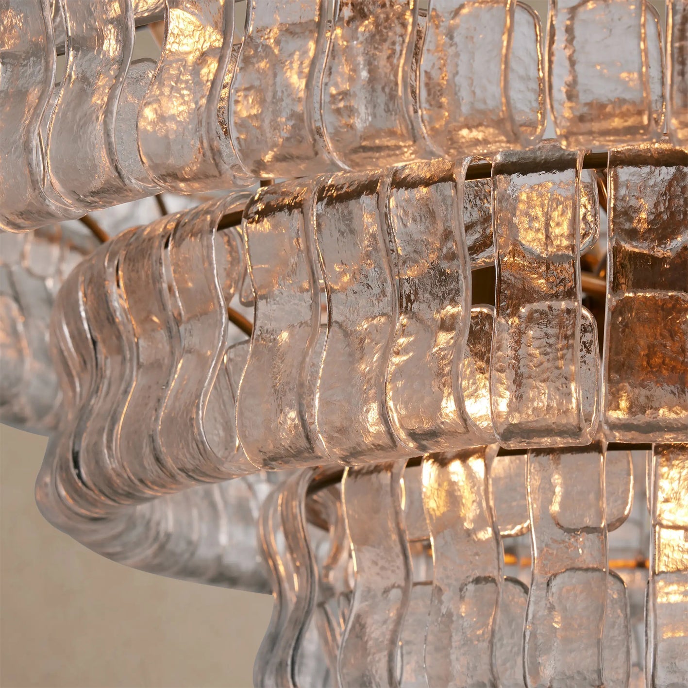 The Ghiaccio Chandelier casting patterns of light on the ceiling.