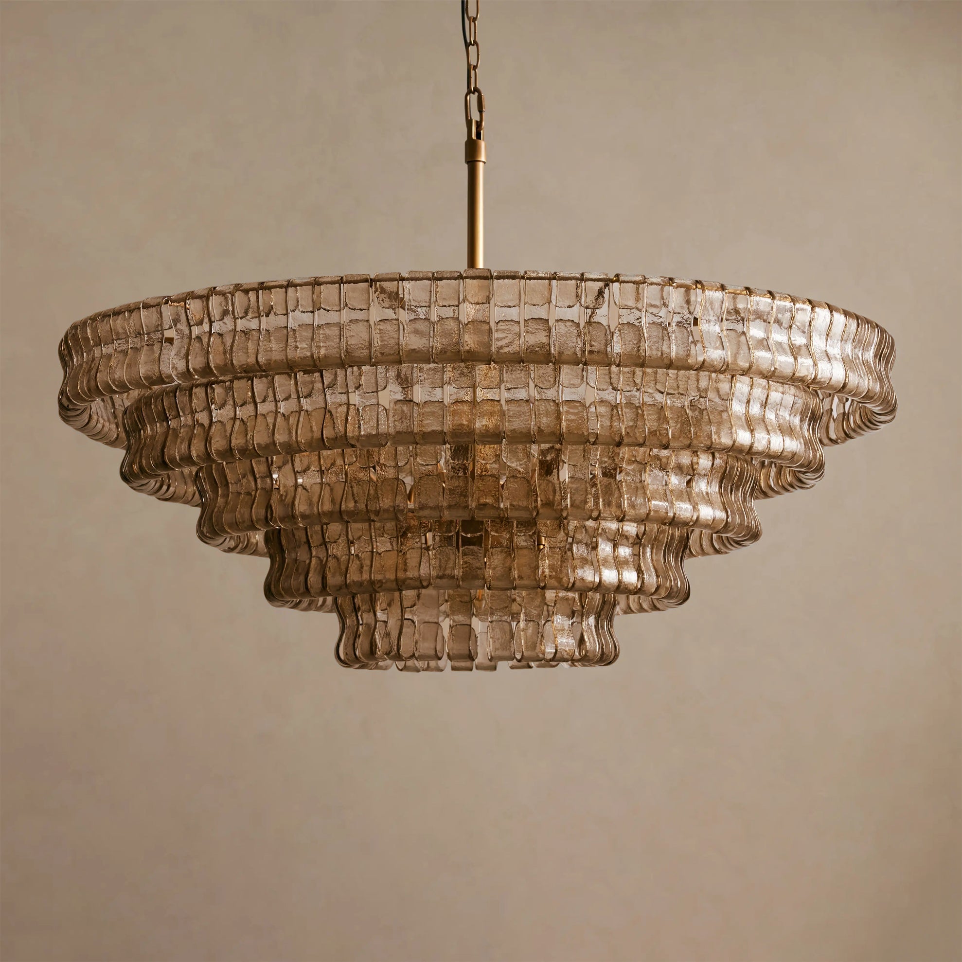 The ambient light cast by the Ghiaccio Chandelier in a dimly lit room.