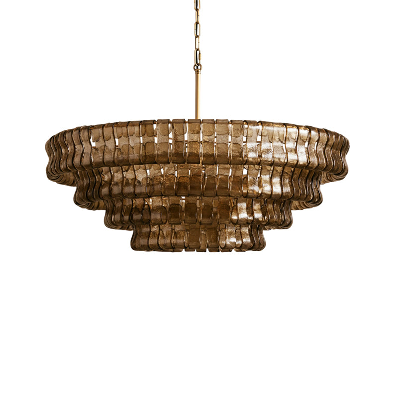 The Ghiaccio Chandelier in a Gold finish, lit and glowing warmly.