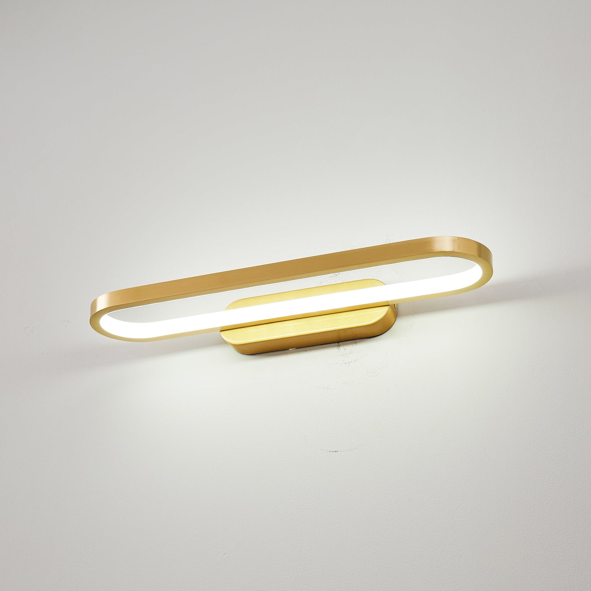 Gianni LED Wall Lamp installed horizontally above a modern bathroom vanity.