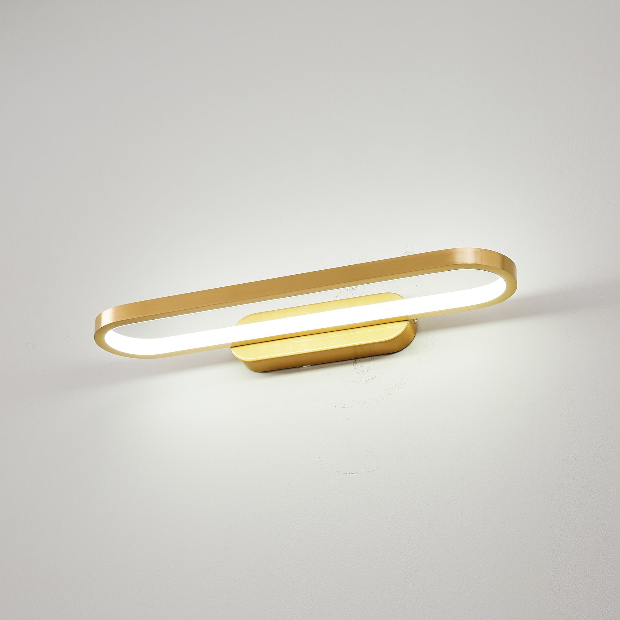 Gianni LED Wall Lamp installed horizontally above a modern bathroom vanity.