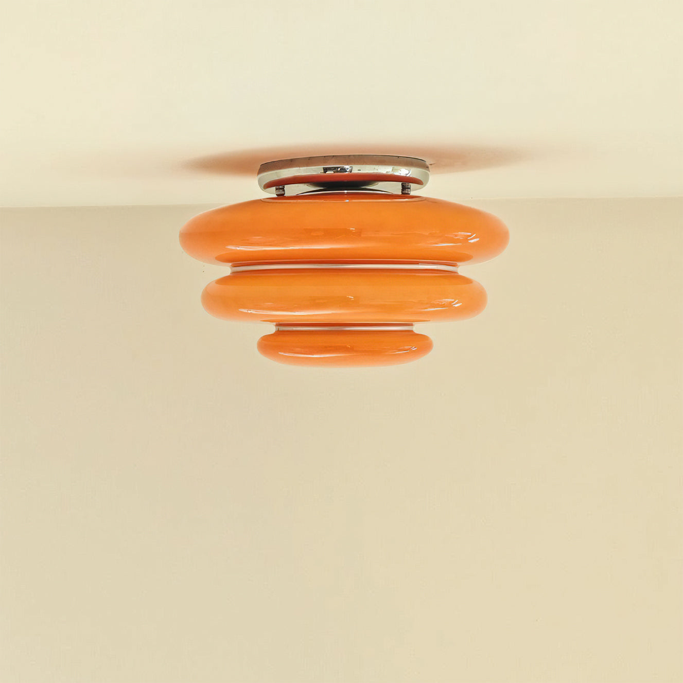 Close-up view of the vibrant orange glass layers on the Gispen ceiling light.