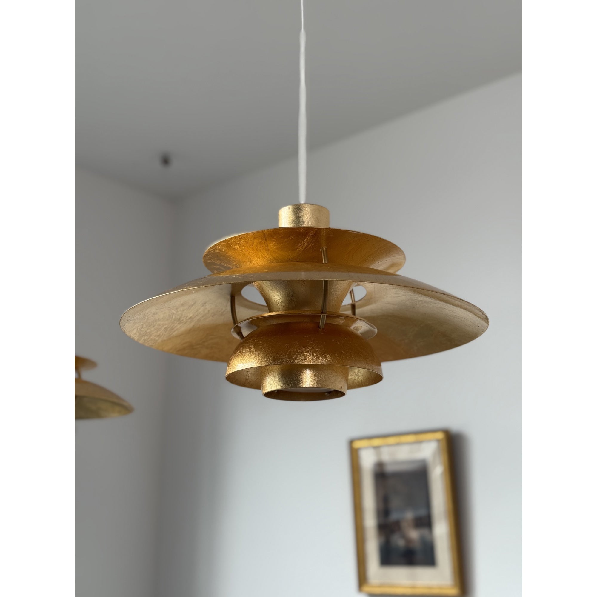 The lamp hanging low over a side table.