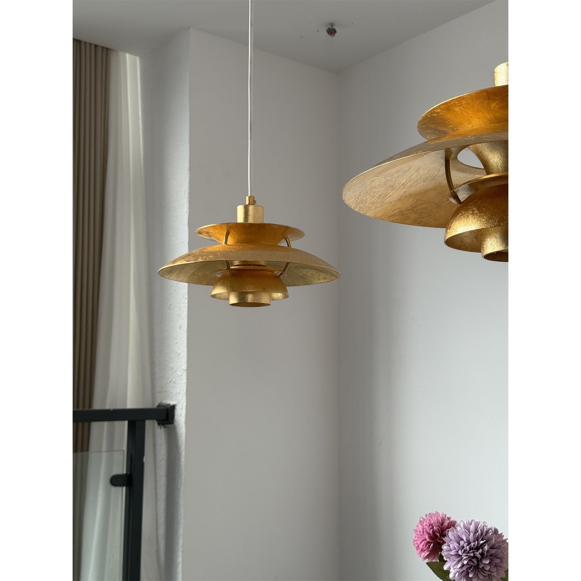 The warm light from the gold foil lamp.